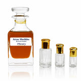 Attar Sheikha by Swiss Arabian, a deep oud, amber and incense perfume oil for men displayed with three gold-capped attar bottles