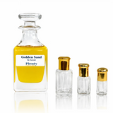 Golden Sand perfume oil, a sweet unisex caramel, vanilla and amber fragrance displayed with three gold-capped attar bottles